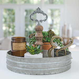 Single tier tray decor featuring an assortment of galvanized decor items, including small plants, candles, and decorative accents arranged for a stylish and cohesive look.